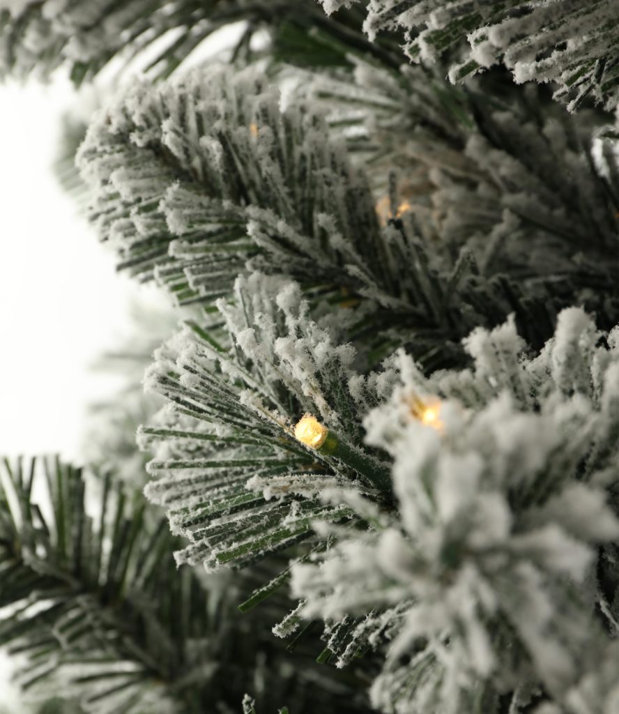 Close up of artificial tree with snow-style flocked branches