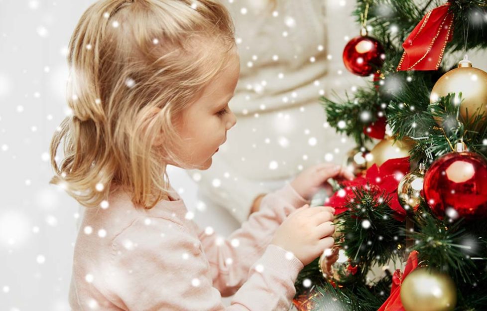 Little girl decorating tree Pic: Shutterstock