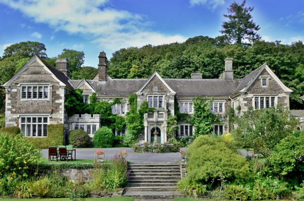 Grey stone house with creeper and steps up to forecourt