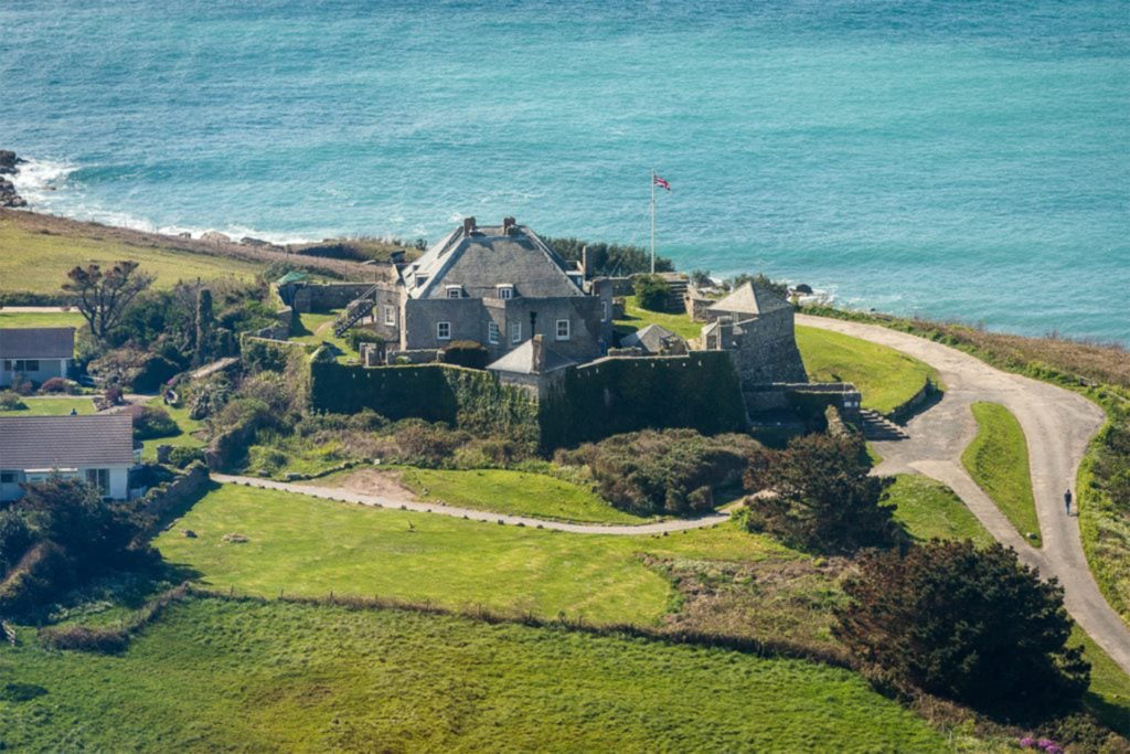 Looking down on to grey stone castle, sea beyond