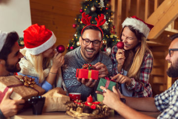 Family Christmas, man opening gift Pic: Shutterstock
