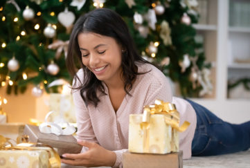 Lady opening Christmas gifts Pic: Shutterstock