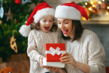 Mum and daughter opening gifts on Christmas day Pic: Shutterstock