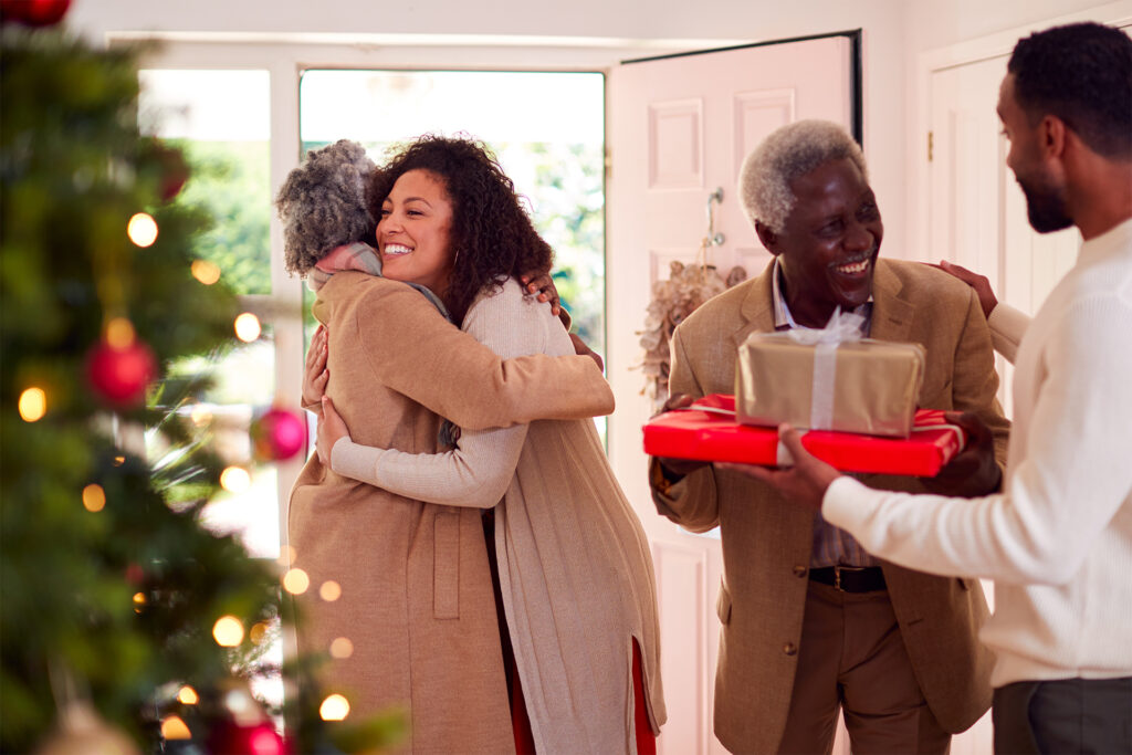 young couple greet parents \rriving for christmas