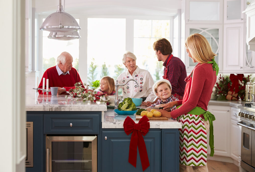 Family in kitchen preparing Christmas meal
