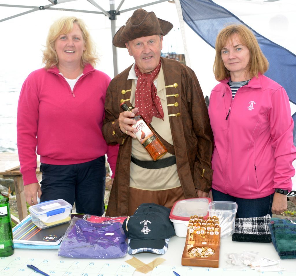 Dodgy sheriff  Alan Walker tried to take the golf club whisky before he had won the treasure hunt. He is pictured with Lorna Campbell, left and Gillian Kitson. 25_c30harbourday08