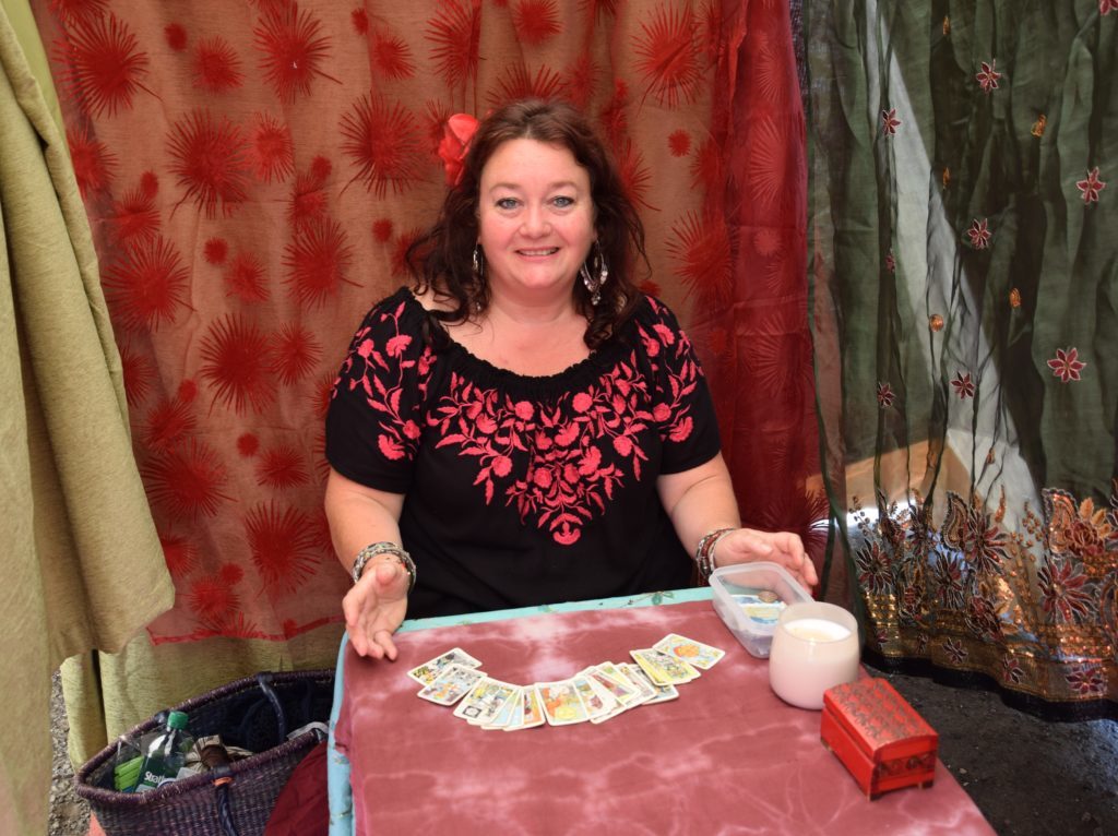 Fortune teller Eleanor Sloan read tarot cards inside a sweltering tent.