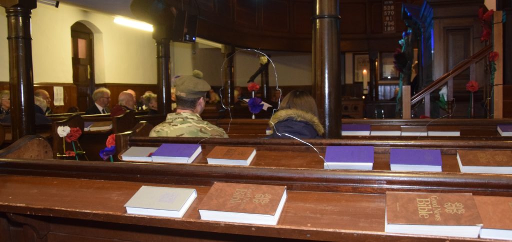 One of the transparent silhouettes representing the Great War's fallen sits in the pews behind Colour Sergeant Robbie Semple.
