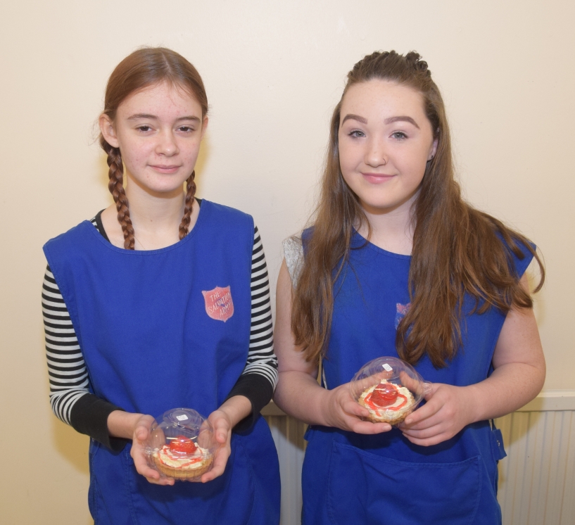 Leah Russell, 13, and Kelsey Graham, 12, hold strawberry tarts made by Kelsey for the event.