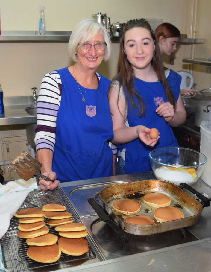 Margaret Raeside and Kelsey Graham prepare some pancakes.