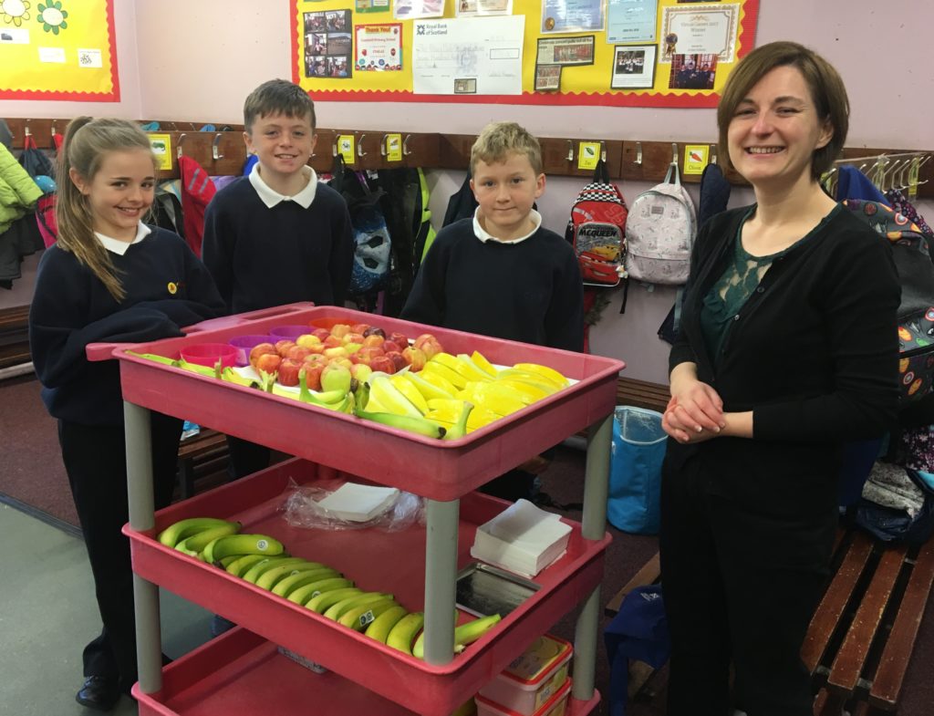 Kerry McGeachy of the parent council helps the children in the tuck shop.