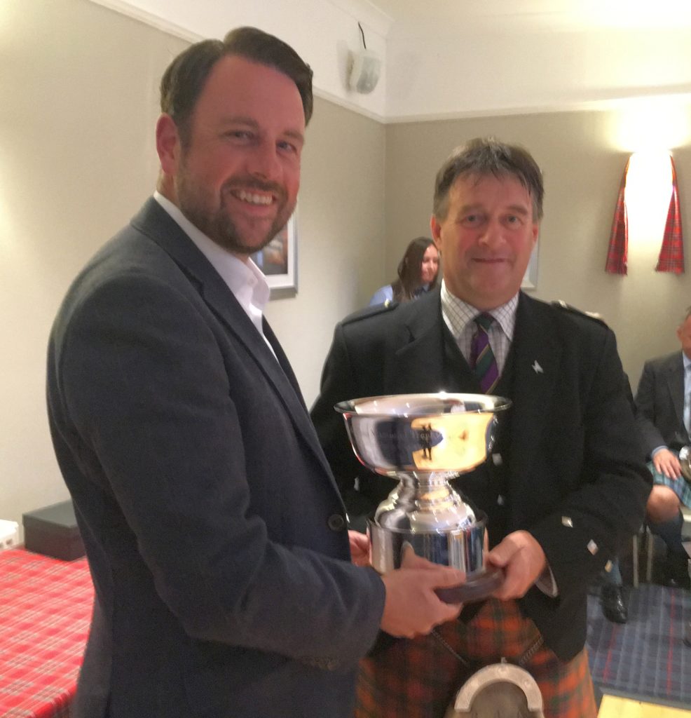 Springbank Distillery's director of sales and marketing, Ranald Watson, presents Angus MacColl with the Willie McCallum Memorial Trophy.