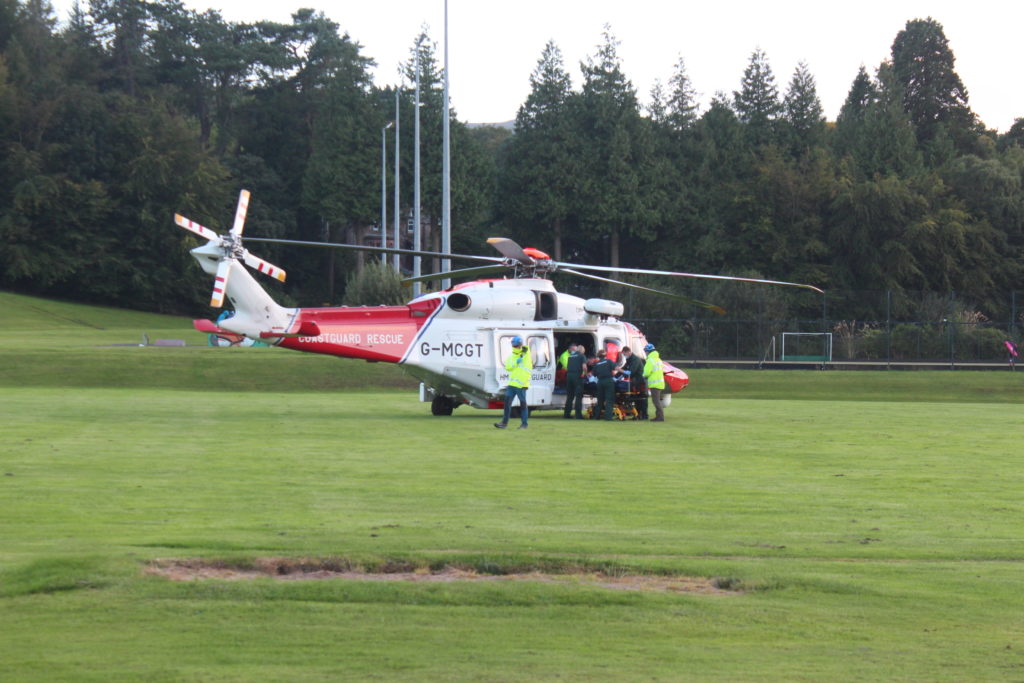 An injured passenger is put in a helicopter to be airlifted to hospital.