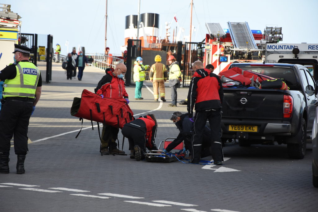The mountain rescue team prepare stretchers at the quayside.