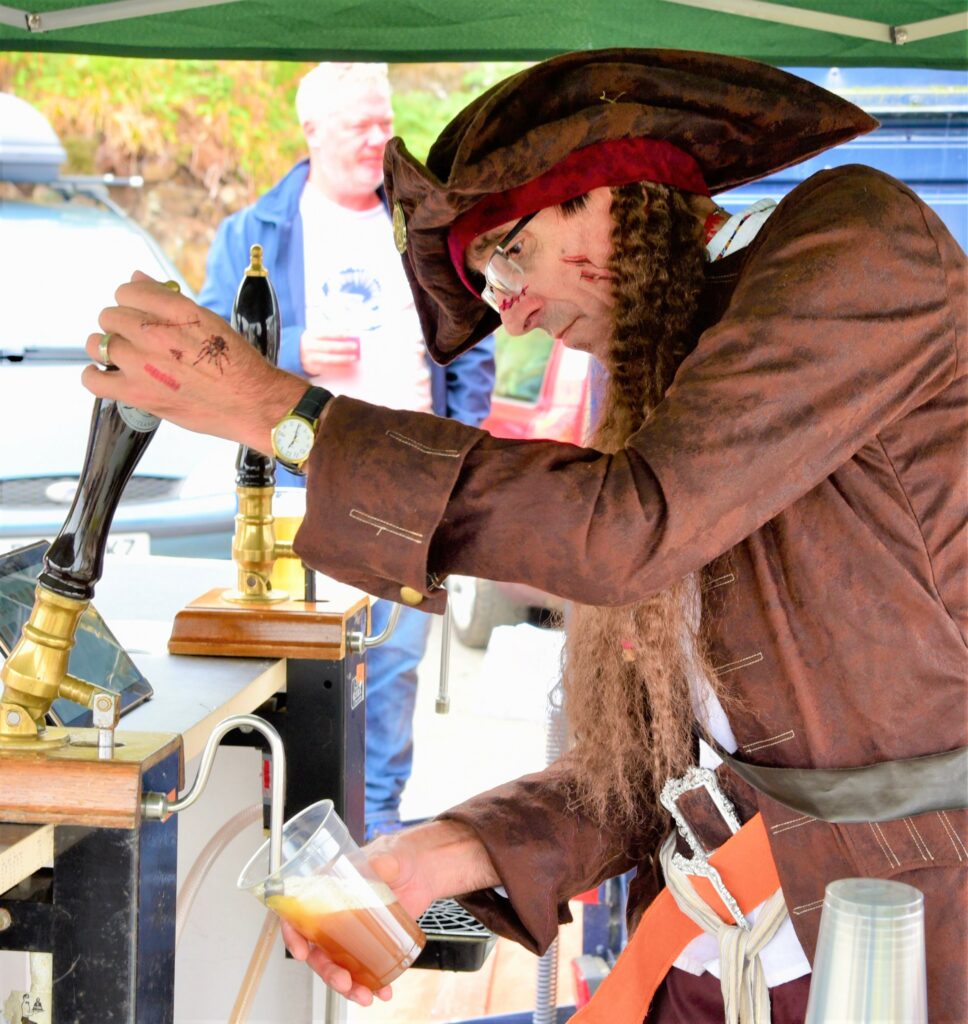 Pirate Ian McGhie pulling a pint of Fyne Ale at the pop-up pub known as the Clam Dredge. Photograph: Alasdair Bennett.