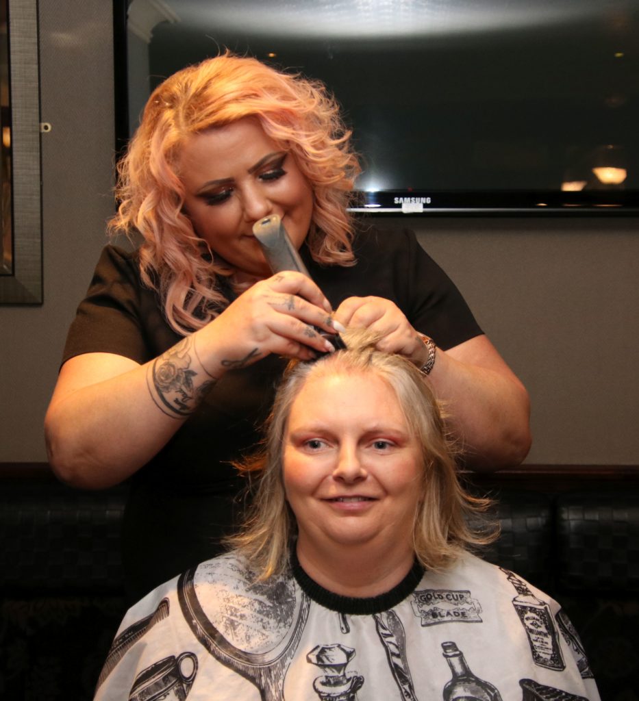 Joanna McMillan was still smiling as hair stylist Kim Mathieson began to cut her hair.
