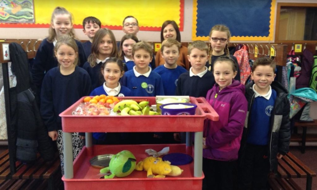Members of Castlehill Primary School's pupil council with Kerry McGeachy, giving out fruit to fellow students.