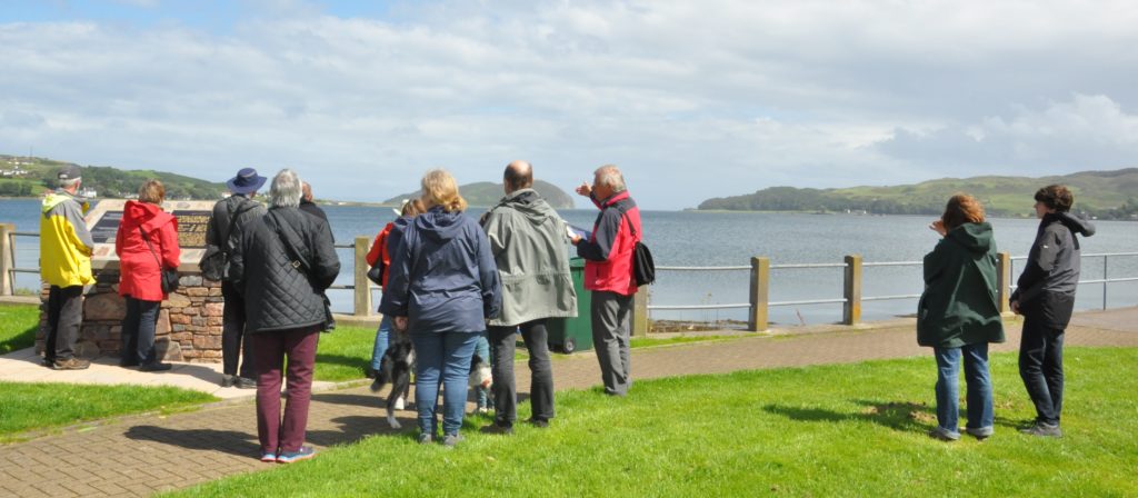 Walkers on a previous tour standing on Quarry Green and looking towards Fort Argyll.