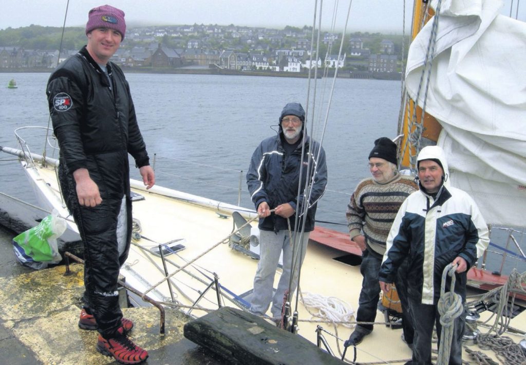 In 2011: Diver Robert Lamont, far left, removed the damaged rudder from Sceptre when she was safely back at Campbeltown Harbour. Also pictured, from left: skipper Tom Smith, Neil Blair and Roger Finbow.