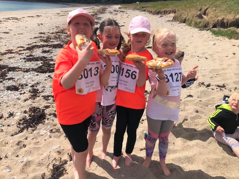 Wee pals Taylor, Erika, Maida and Emma enjoying some obligatory MOKRUN Danish pastries after completing their one-mile run on Saddell beach.