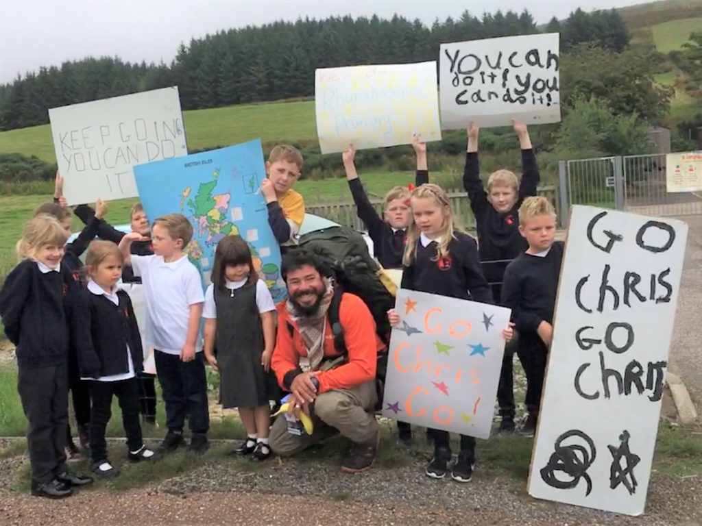 Rhunahaorine's pupils made banners and posters to greet coastal walker Chris Howard.