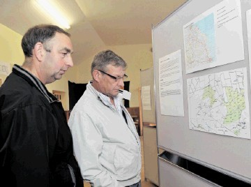 PLANNING AHEAD:  Local residents  Alistair McLeod, left,  and Brian Tait study the maps of the proposed windfarm on Mormond Hill