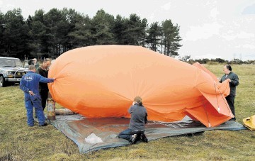 FLYING HIGH: Protesters flew an  orange blimp  to 500ft at Abriachan to show the size of a proposed development there