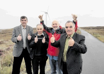 Donald John Macsween, second right, and other Point residents celebrate yesterday while visiting  other turbines