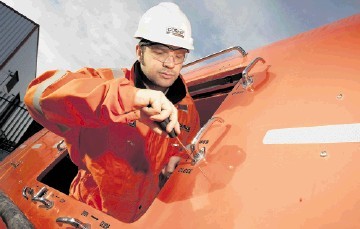 PROFITABLE DIVISION: Cosalt Offshore technician Iain Ridehalgh at work on a lifeboat