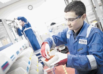 HIGHLY SKILLED: Trainee technician Neils Wood, right, and installation technician Jason Benzie, at Nessco’s workshop