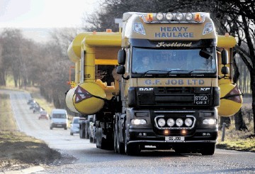 HEAVY LOAD: The two lorries with a police escort head north from Invergordon. Gordon Lennox