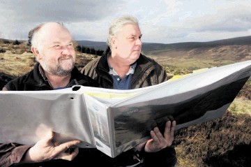 FIGHTING ON: John Edmondson, left, and Peter Allen  with drawings of the  windfarms  planned for Ardross. Sandy McCook