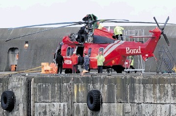 SALVAGED:  The downed helicopter is lifted off the Seven Pelican after arriving at Peterhead harbour yesterday. Kenny Elrick