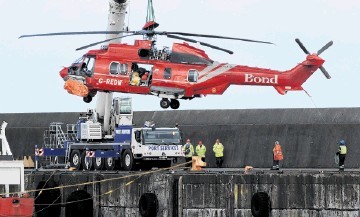 SHOCKWAVES: Shell called off its deal with Bond after the ditching of this Super Puma – seen being lifted  ashore at  Peterhead. Kenny Elrick