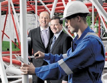 UPBEAT: Doug Duguid, left, and UK manager Stuart Smith watch Ryan Nicol working on a crane boom