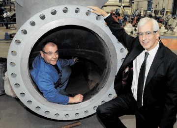 IN THE GROOVE: Maurice Critchley, CEO of Severn Glocon Group, with a machinist working inside a large oilfield valve assembly