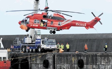 WARNING LIGHTS: Bond G-REDW being lifted off the Seven Pelican at Peterhead Harbour after it ditched. Kenny Elrick