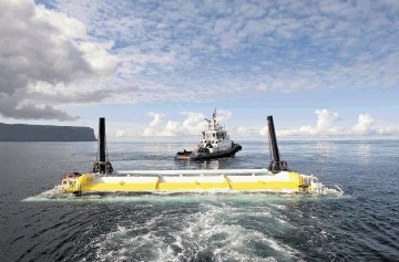 SEA POWER: A wave energy  converter is towed into position in the waters between Orkney and Caithness