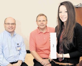 Peterhead Academy pupil Beth Warrender shows the iPad she won to acting head teacher Tim McKay, left, and deputy head teacher Evan Ritchie