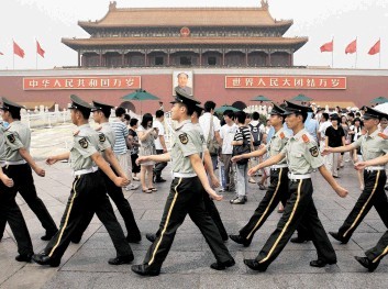 MARCHING ORDERS: Soldiers march past the entrance to the  Forbidden City