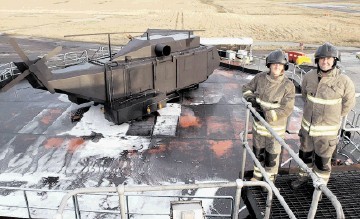 REALISTIC: Catherine Liebnitz, left, and FTG fire training supervisor Steven Wilson on the mock helideck