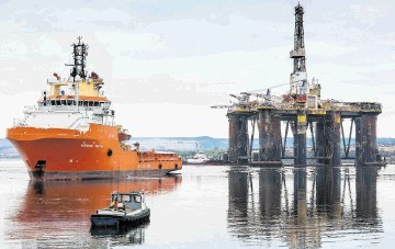 SAILING AWAY: The semi-submersible rig was tugged to Queens Dock and will now undergo a major refit benefiting the Easter Ross area