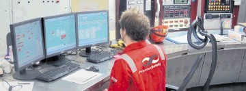 A PSS Systems Engineer  reviewing DeltaV  graphics in the Duty Room, North Alwyn