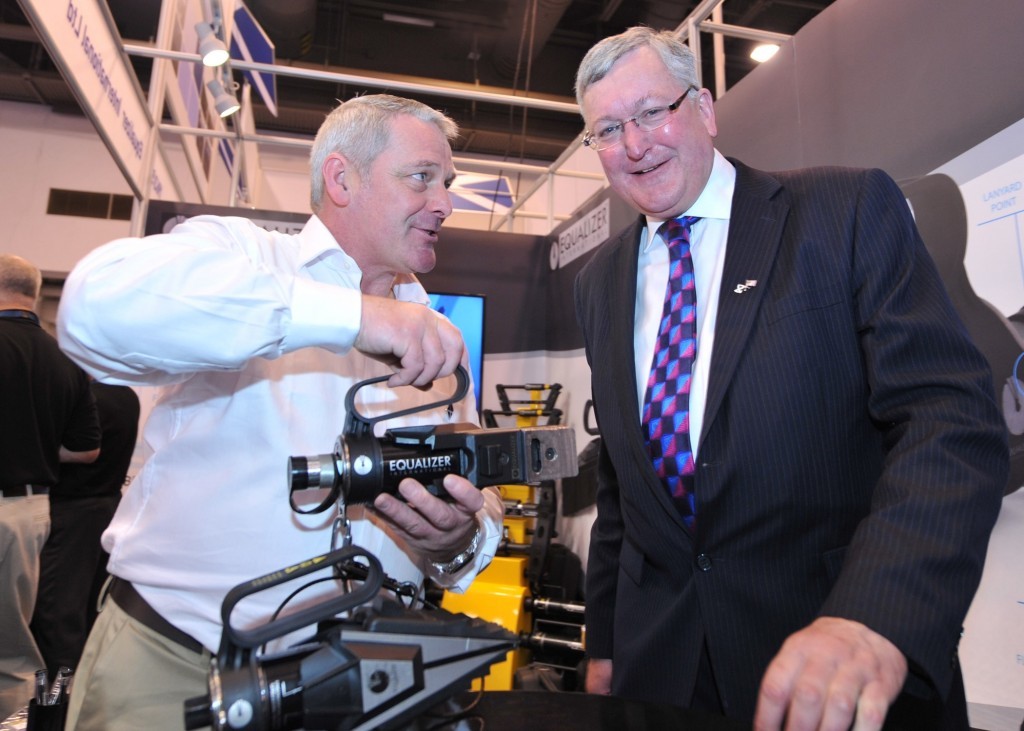 Bob Stephen, technical director with Equalizer International, shows off one of his company's tools to Scotland's Energy Minister Fergus Ewing at OTC. Picture by Barchfeld Photography.