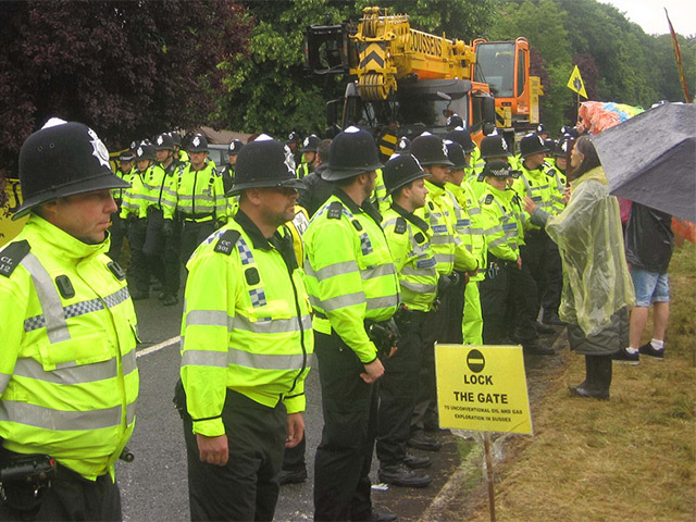 Police protect fracking site vehicles from protesters