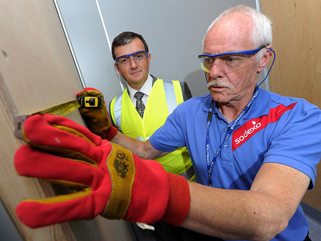 PROMOTED: Ian Russell, left, watches Sodexo colleagues at work. Pic: Kenny Elrick