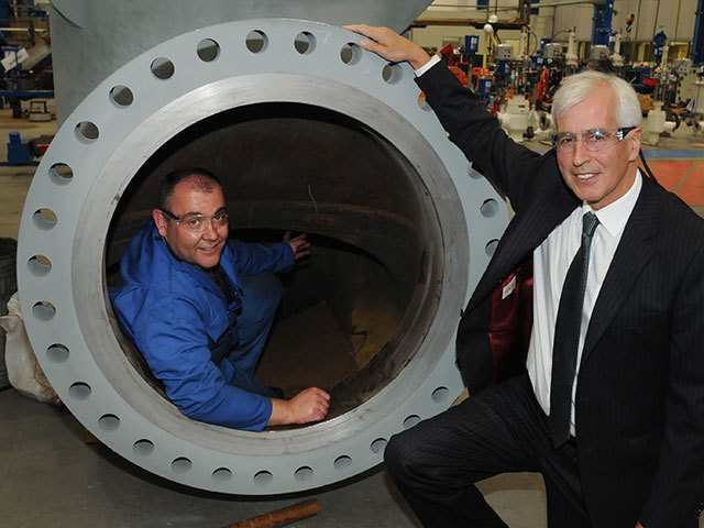 Maurice Critchley, CEO of  Severn   Glocon   Group  with a machinist working inside a large oilfield valve assembly