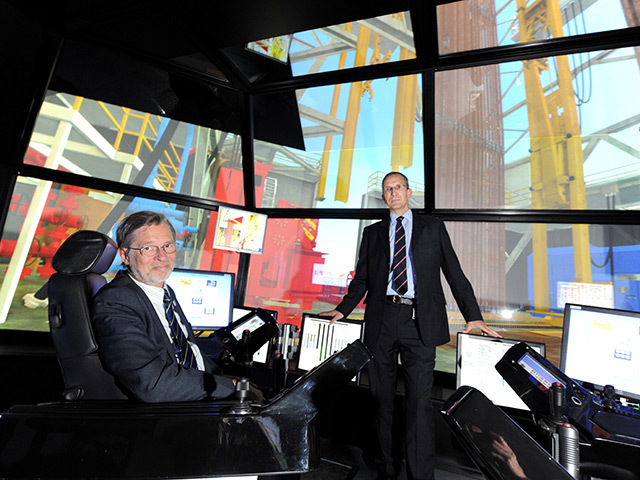 Prof Ferdinand von Prondzynski, left, and Jack Winton of KCA Deutag, sample the new DART simulator at RGU.