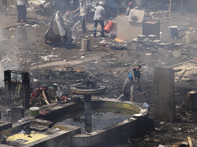 Morsi supporters throw rocks during a violent crackdown by Egyptian Security Forces in Cairo