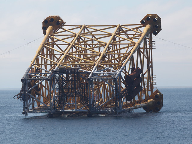 The drilling and production jacket is towed into position on the installation barge